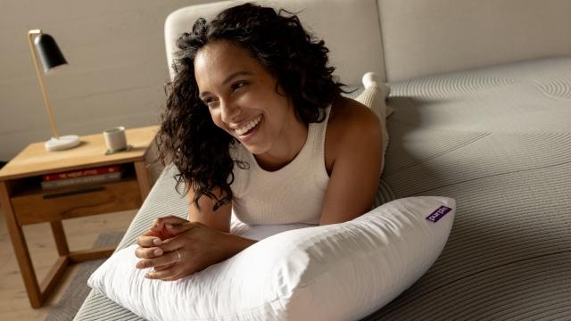 woman smiling with pillow