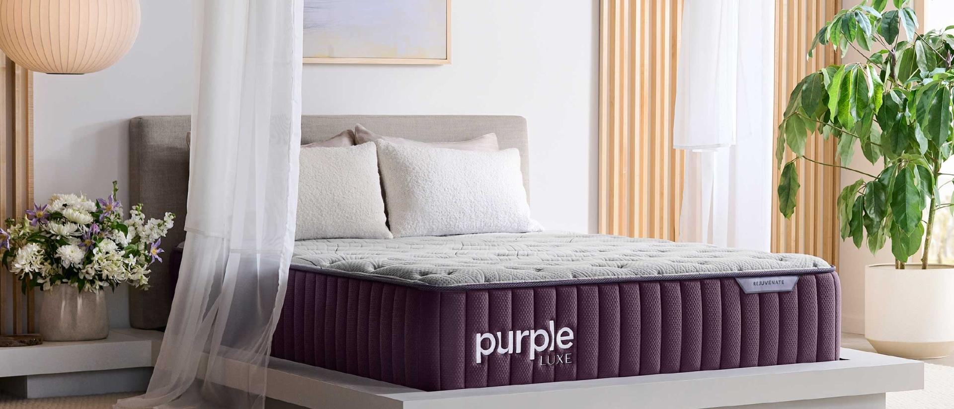 The thick Purple Rejuvenate™ Mattress on a modern bed frame in a bedroom.
