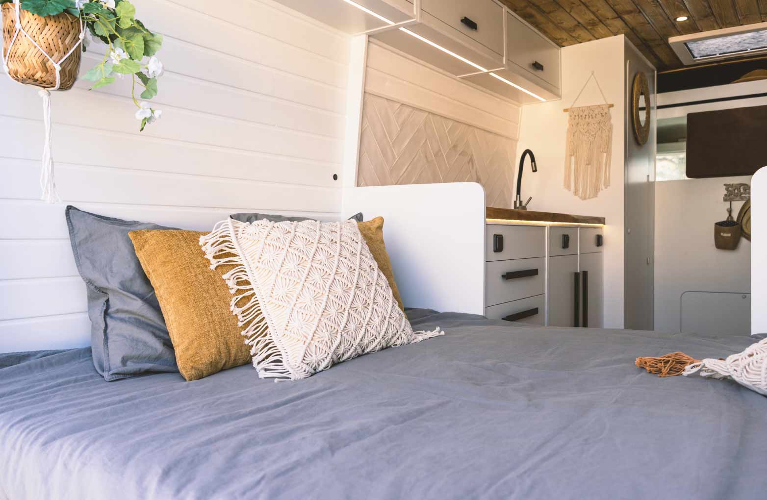 A short queen mattress in a cozy RV bedroom.