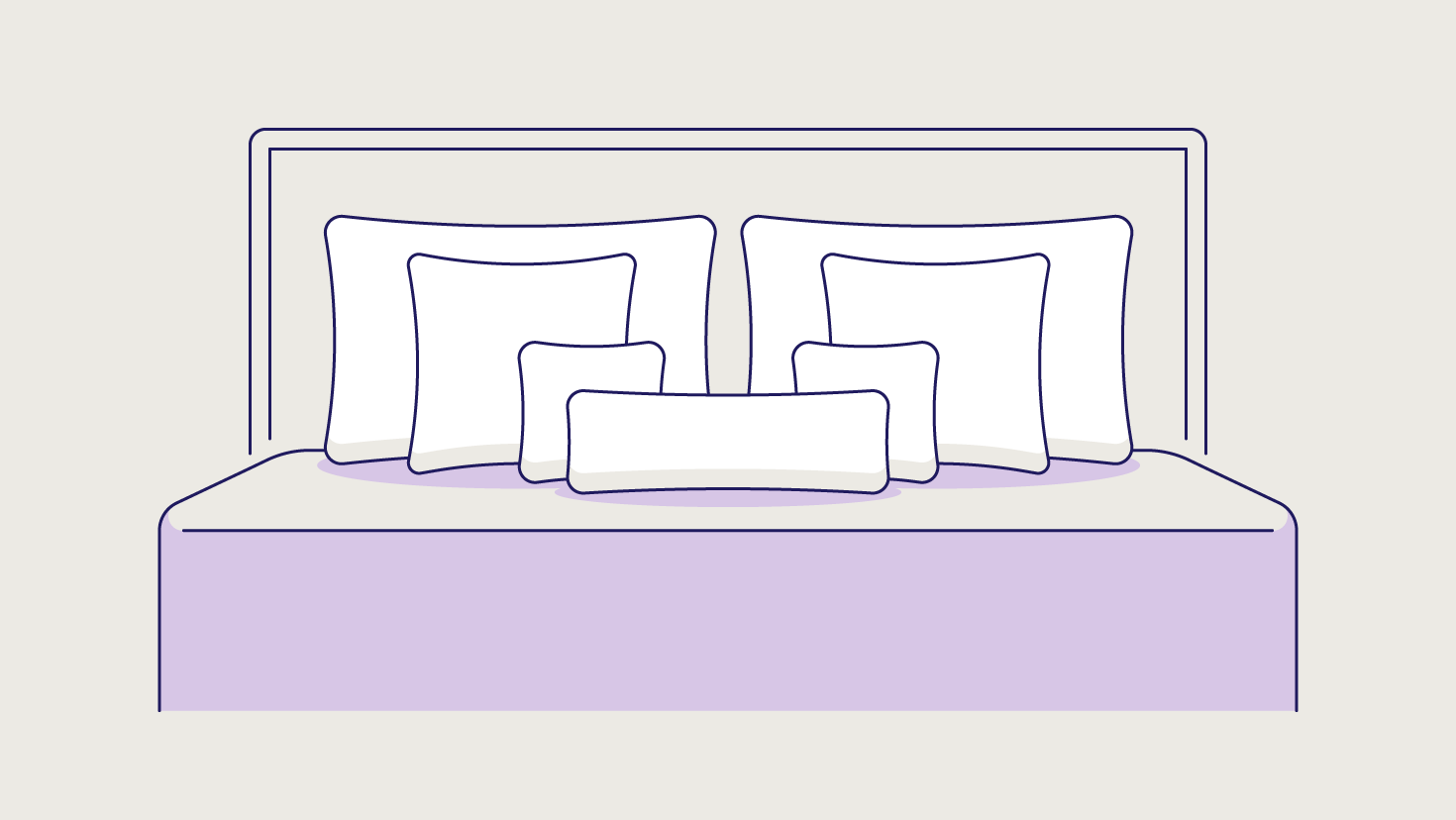 A lumbar pillow in front of two small square pillows, two Euro pillows, and two king size pillows.