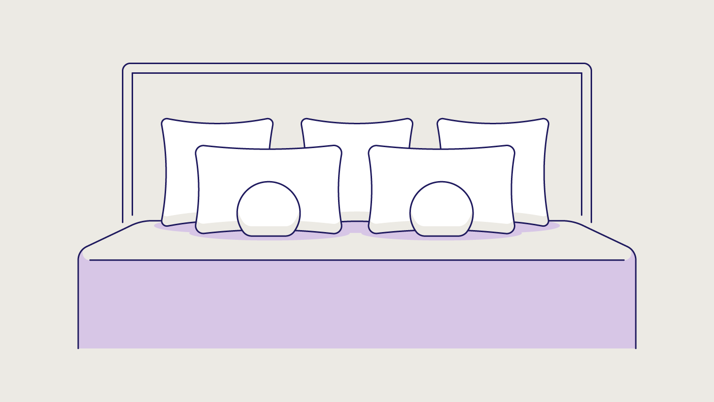 Two decorative pillows in front of two standard pillows and three Euro pillows.