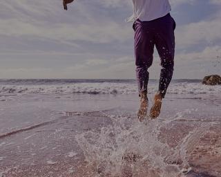 Man Jumping By Ocean