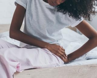 A woman experiencing hip pain from a bad mattress.