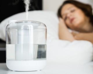 A woman sleeps with a humidifier running in the bedroom.