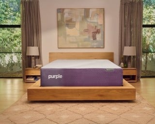 A RestorePlus hybrid mattress in a well-lit bedroom.