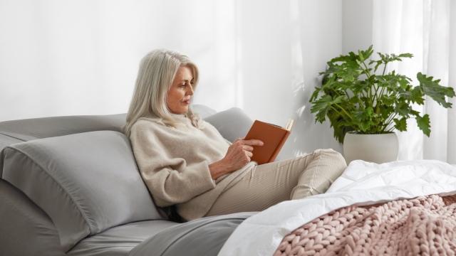 Woman reading a book on Purple Bed Set