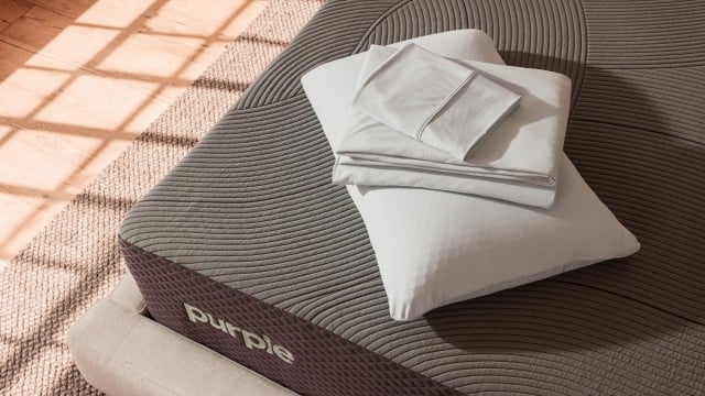 Harmony Pillow and SoftStretch Sheets stacked on corner of mattress