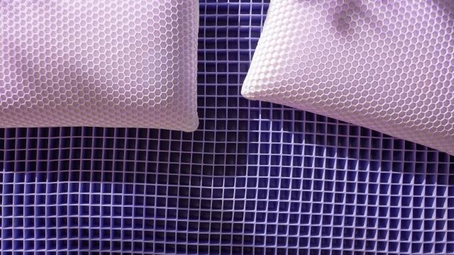 Exposed gid Harmony pillows on a Purple mattress