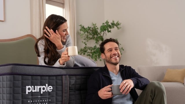 Man and woman sitting on bed