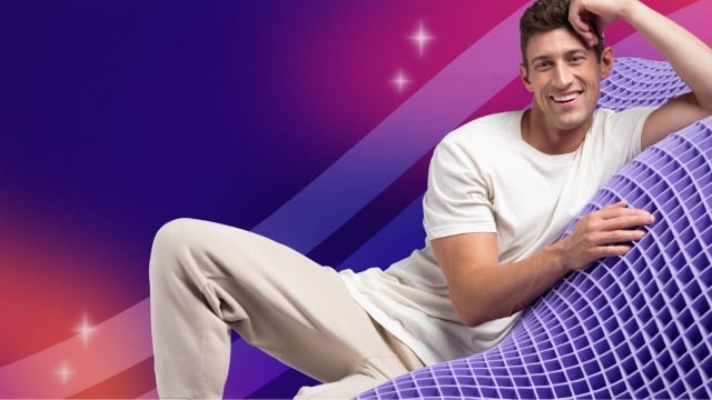 Man laying on GelFlex Grid with rainbow gradient background