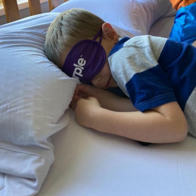 Kid Sleeping On Purple Mattress