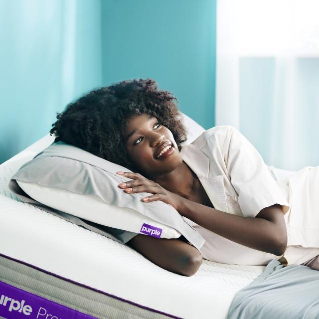 Model with hybrid premier mattress and harmony pillow