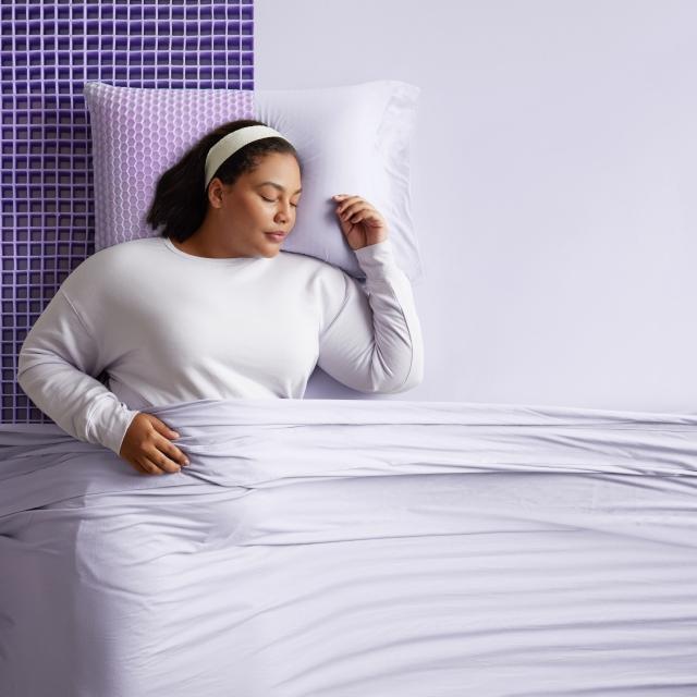woman on purple mattress with grid exposec