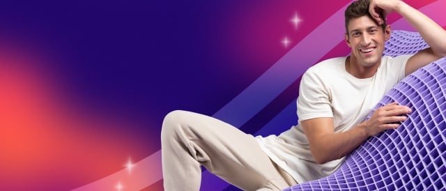 Man laying on GelFlex Grid with rainbow gradient background