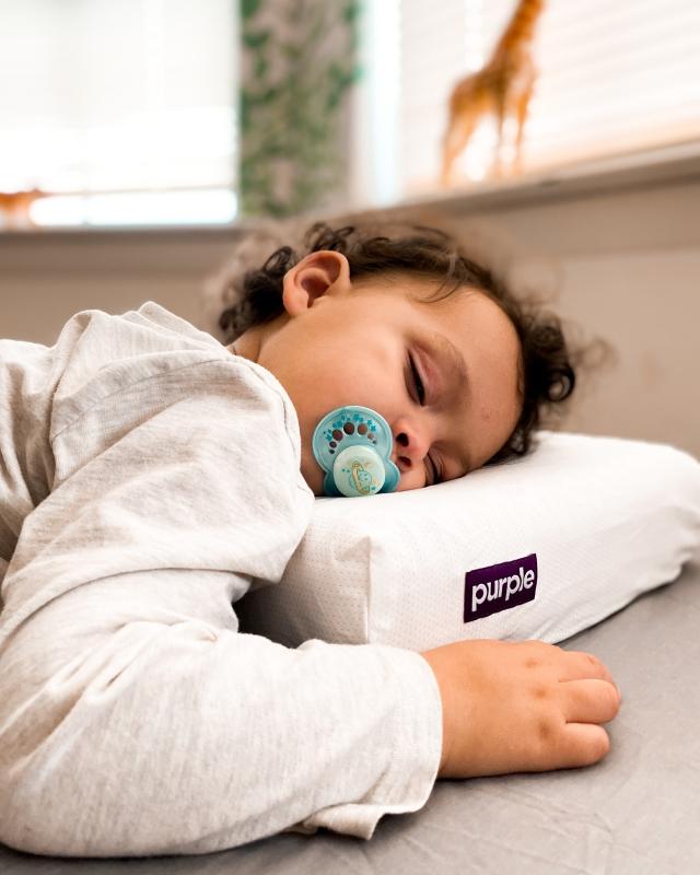 Baby sleeping on Kid Purple Pillow