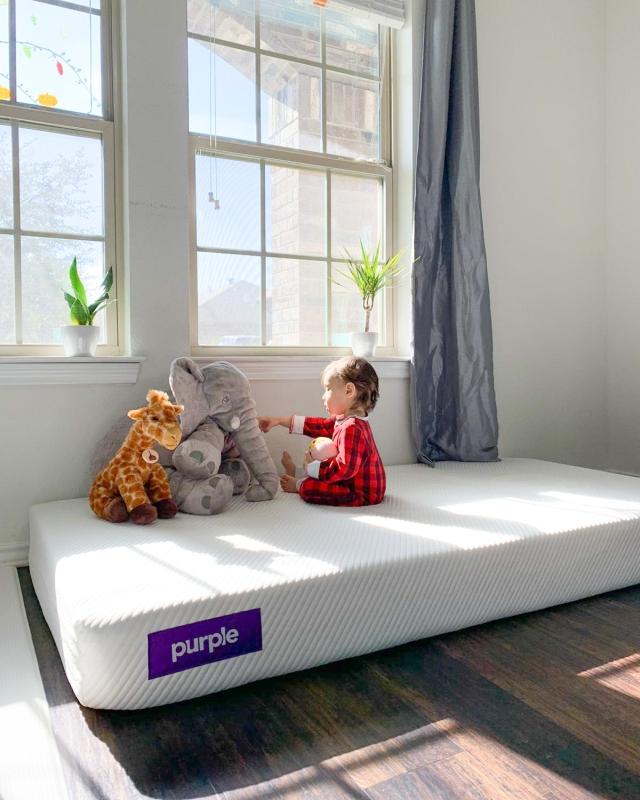 Baby playing on a Purple mattress