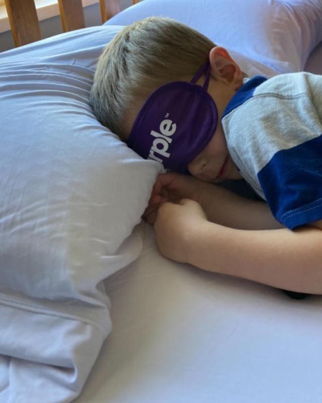 Kid Sleeping On Purple Mattress