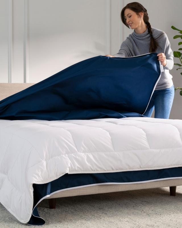 Woman putting on duvet cover