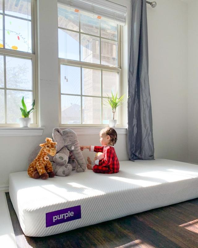 Baby playing on a Purple mattress