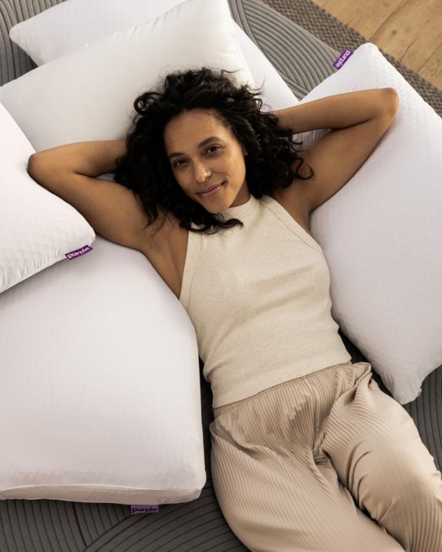 woman laying on pile of pillows