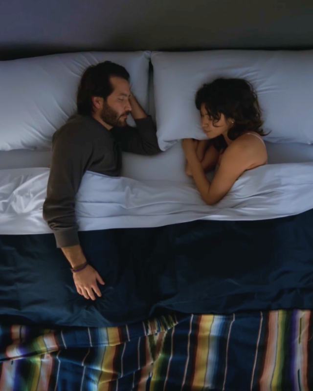 Couple in bed with SoftStretch sheets
