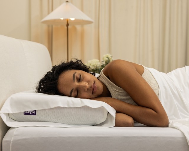 woman sleeping on purple pillow