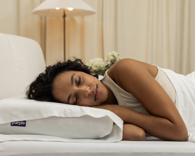 woman sleeping on purple pillow