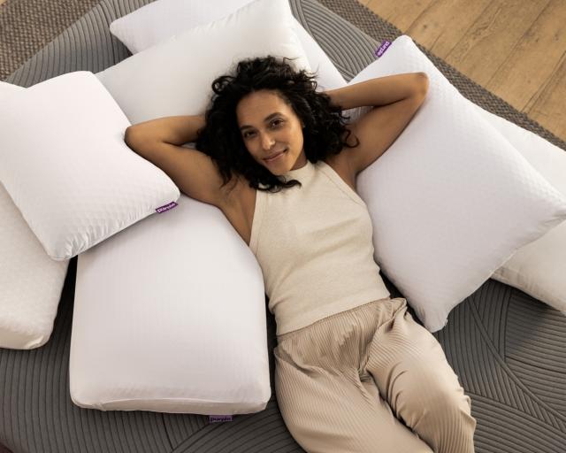 woman laying on pile of pillows