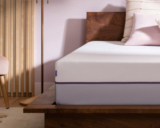 Image of Purple mattress with pillows on it.