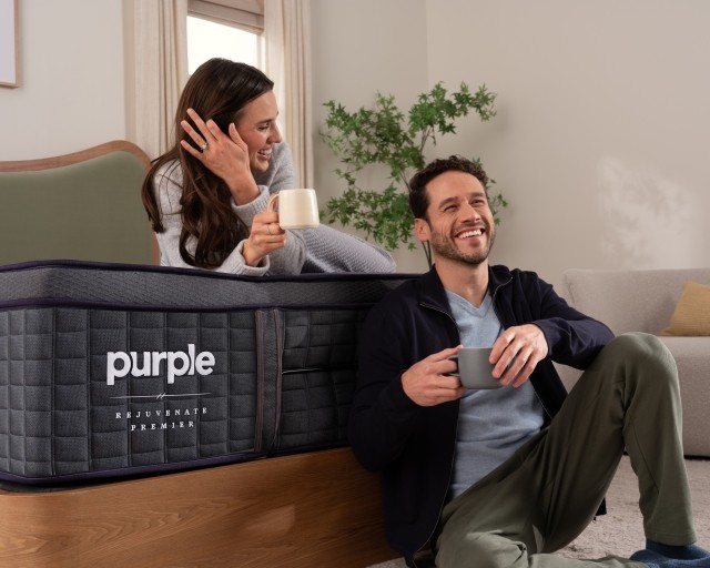 Man and woman sitting on bed