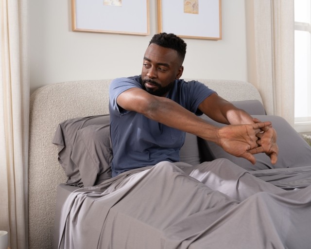 SS sheets gray with talent sitting in bed