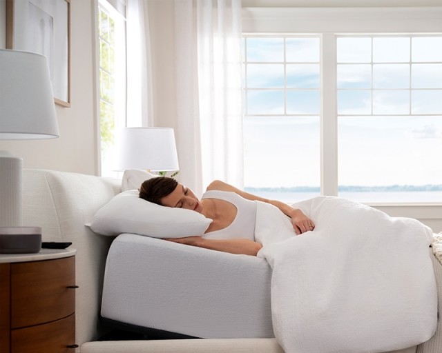 A woman sleeping on the purple smart base mattress