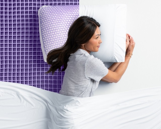 Woman sleeping on exposed Grid pillow and Grid mattress