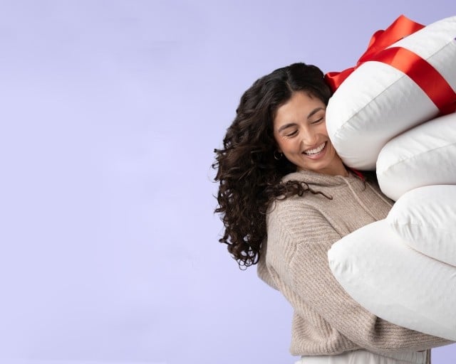 woman holding harmony pillows