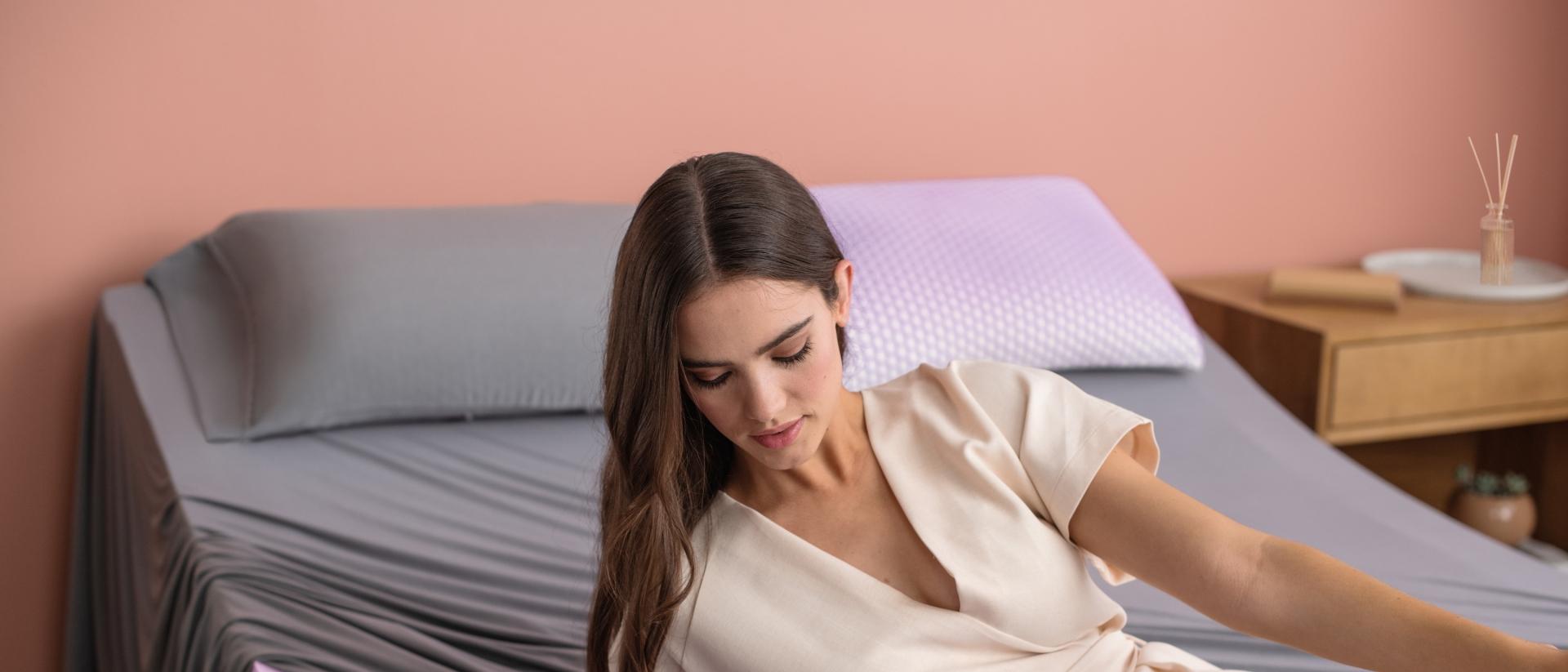 woman laying on mattress with the purple grid