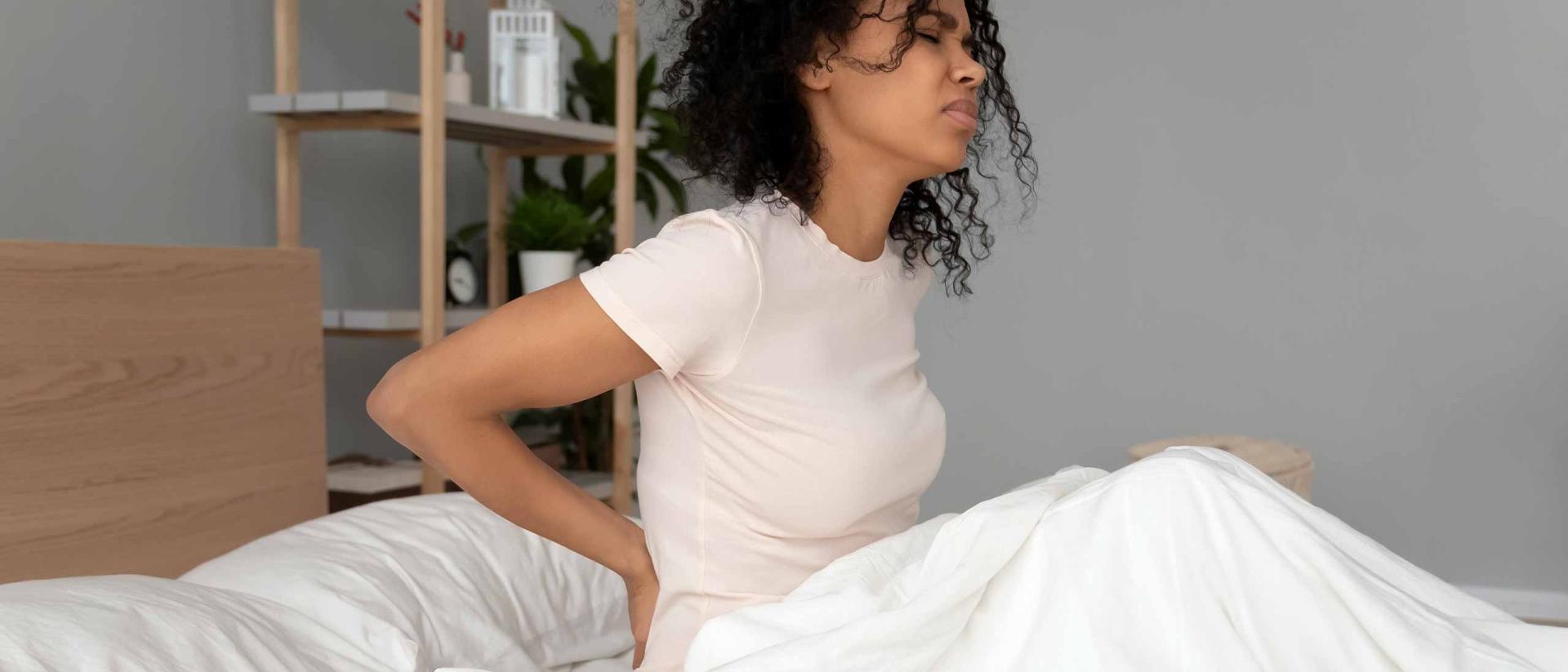 Woman waking up with sore back