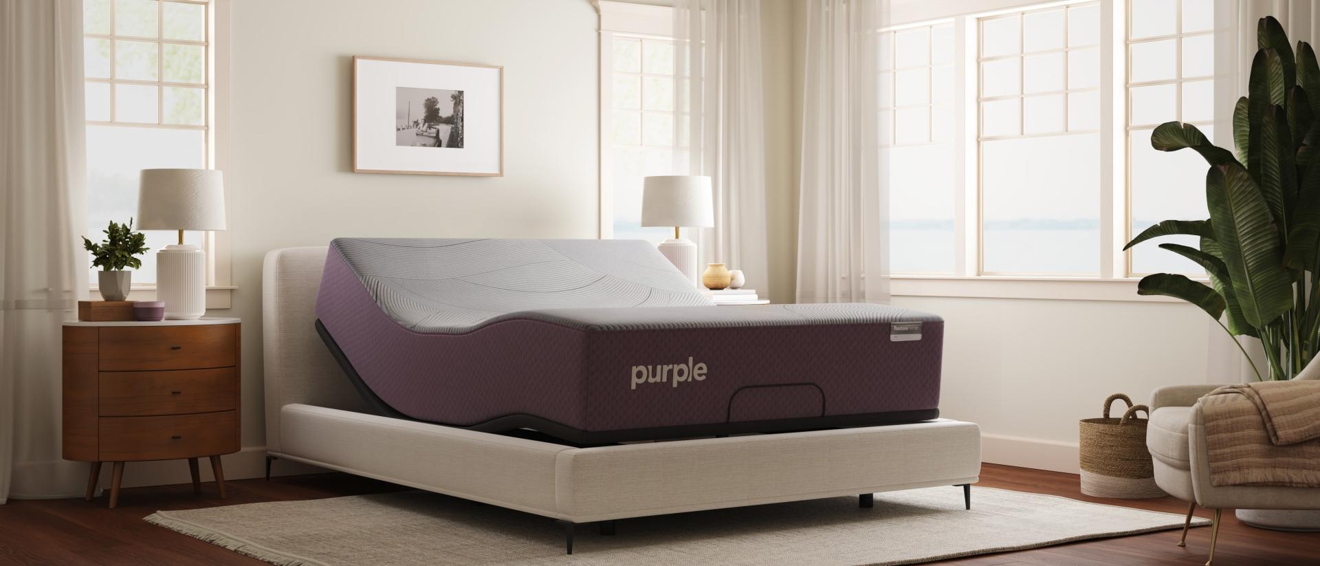 Purple RestorePremier Hybrid mattress on the Purple Premium Smart Base in a bright bedroom.