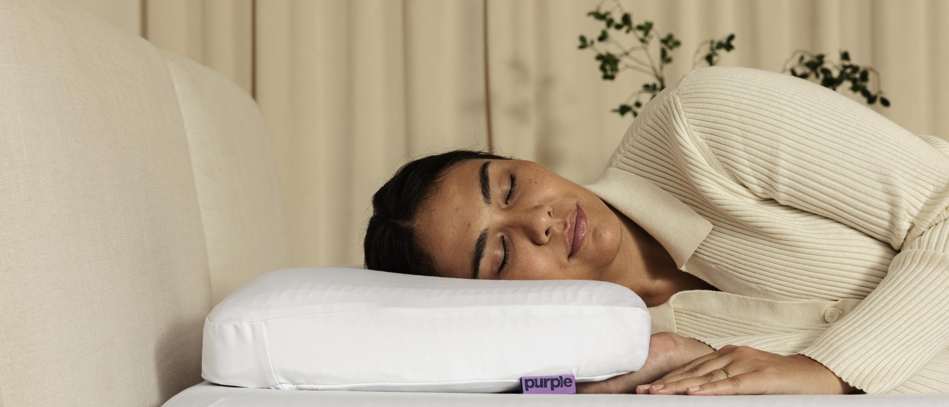 Person sleeping on a Purple pillow.