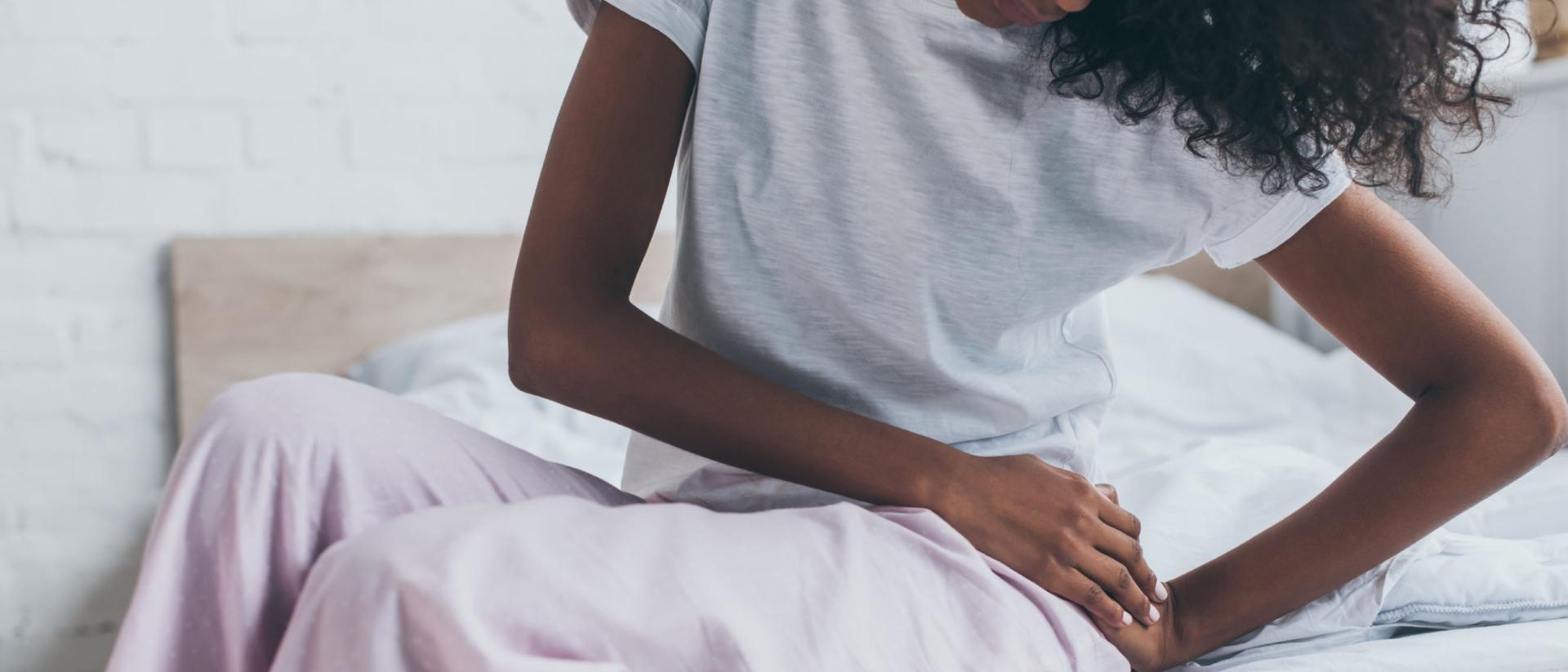 A woman experiencing hip pain from a bad mattress.