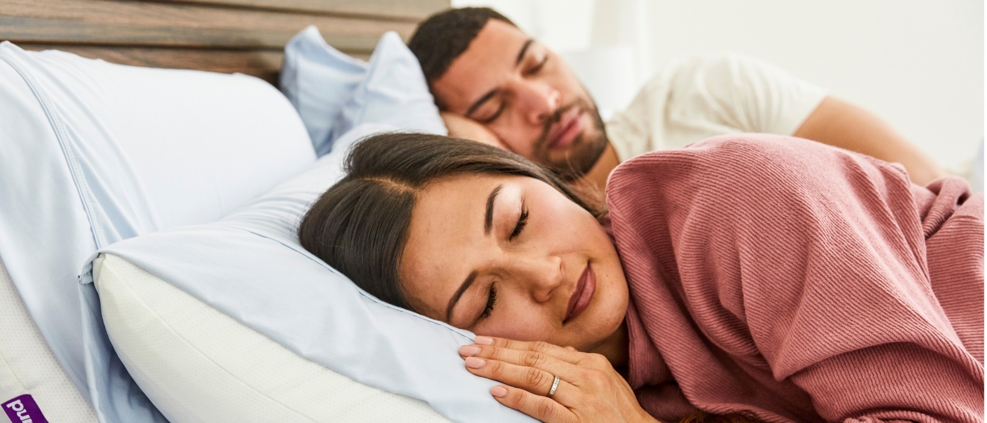 couple sleeping on dressed bed