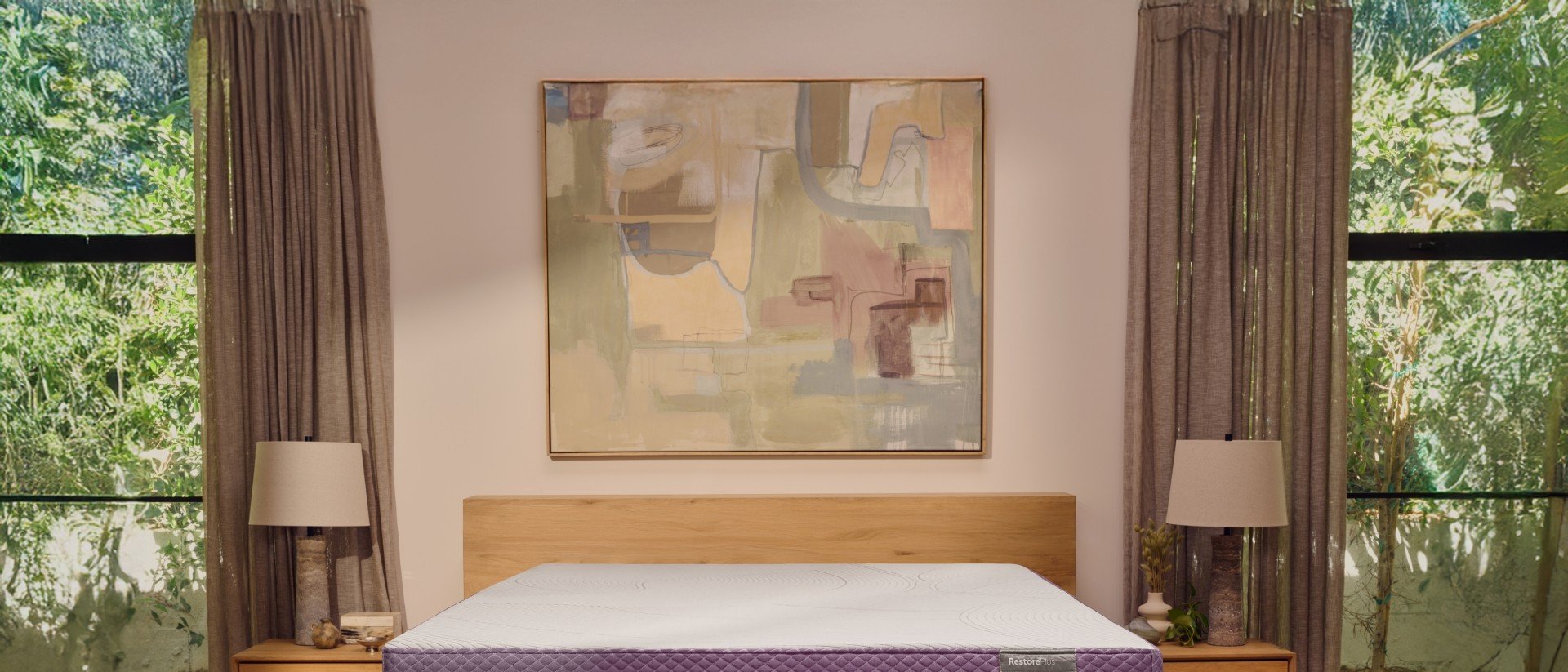 A RestorePlus hybrid mattress in a well-lit bedroom.