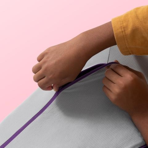 Kid unzipping Purple Kid's Pillow