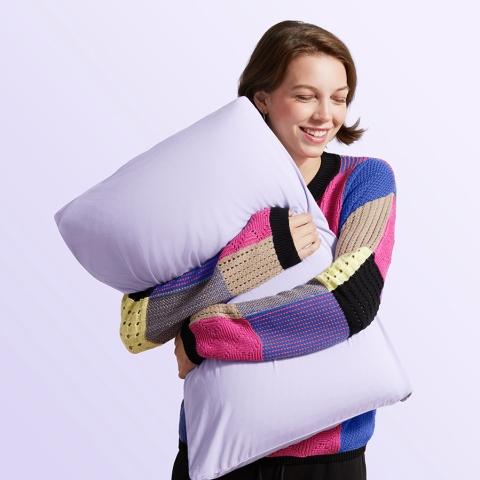 woman hugging pillow with softstretch pillowcase