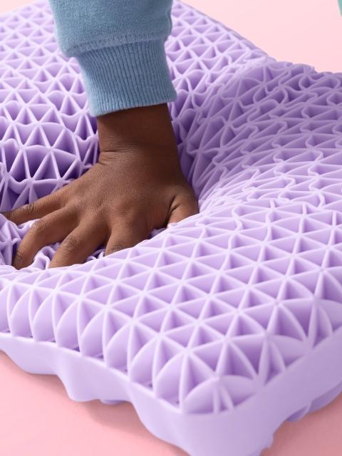 Kid's hand squishing Kid Purple Pillow