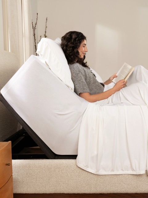 Woman on a Rejuvenate mattress with adjustable base