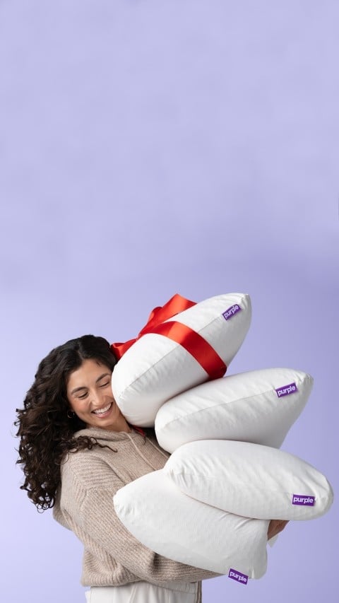 woman holding harmony pillows